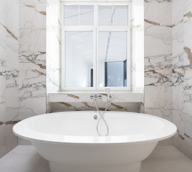 Luxury bathroom remodel with freestanding tub and marble finishes for a 30A home