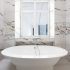 Luxury bathroom remodel with freestanding tub and marble finishes for a 30A home
