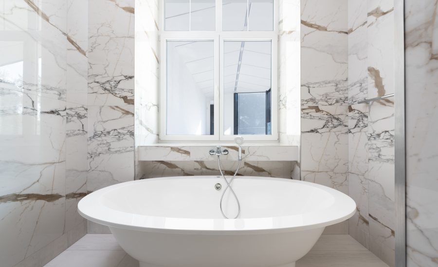 Luxury bathroom remodel with freestanding tub and marble finishes for a 30A home