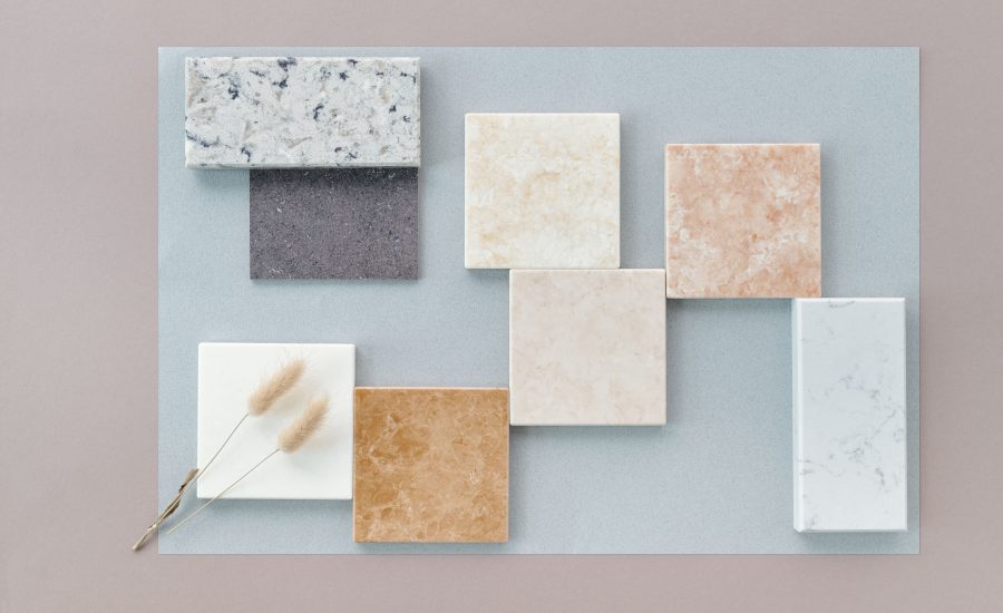 Luxury tile and stone samples in marble, quartzite, and porcelain arranged on a flat lay for a 30A remodel