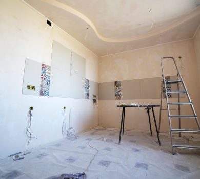Interior room under renovation with paint, tile, and tools for a 30A remodeling project