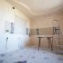 Interior room under renovation with paint, tile, and tools for a 30A remodeling project