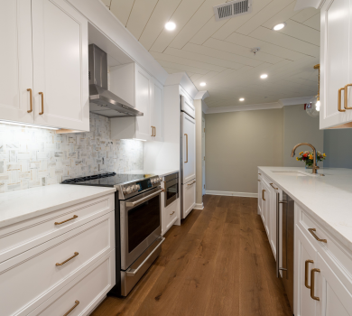 30A home remodel featuring a white kitchen with custom cabinetry and gold hardware