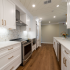 30A home remodel featuring a white kitchen with custom cabinetry and gold hardware